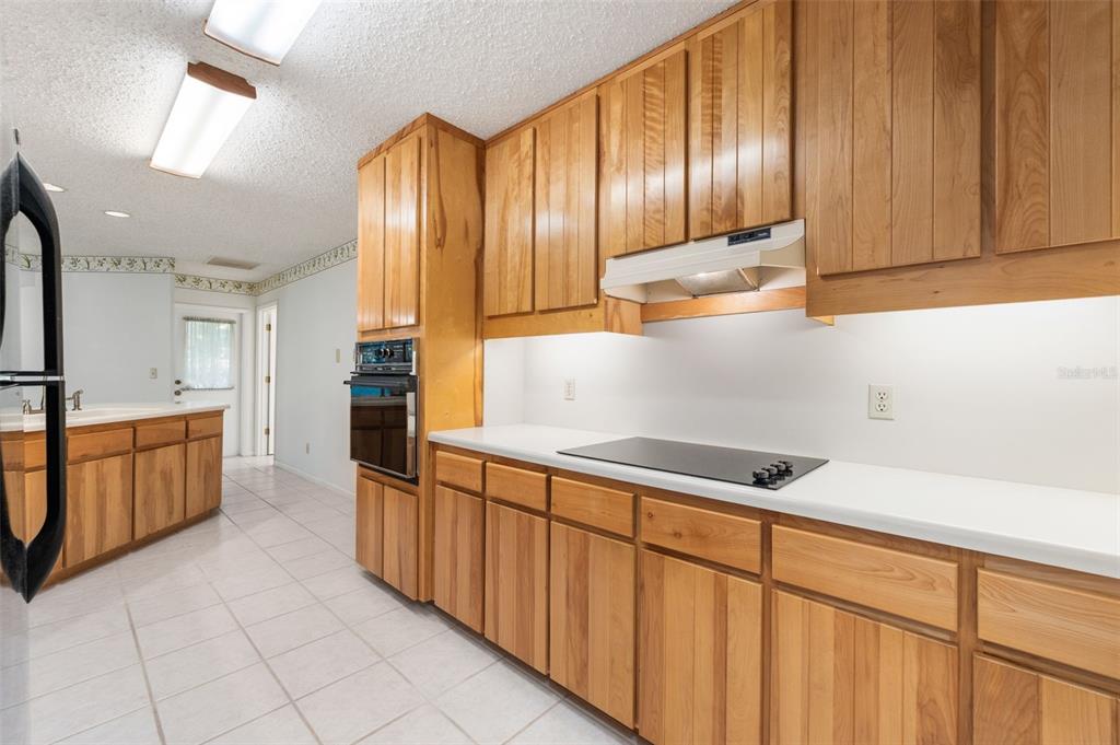 11606 Northwest 120th Terrace Alachua, FL 32615 - Photo 26 of 46 a kitchen with stainless steel appliances granite countertop a refrigerator a stove and a sink