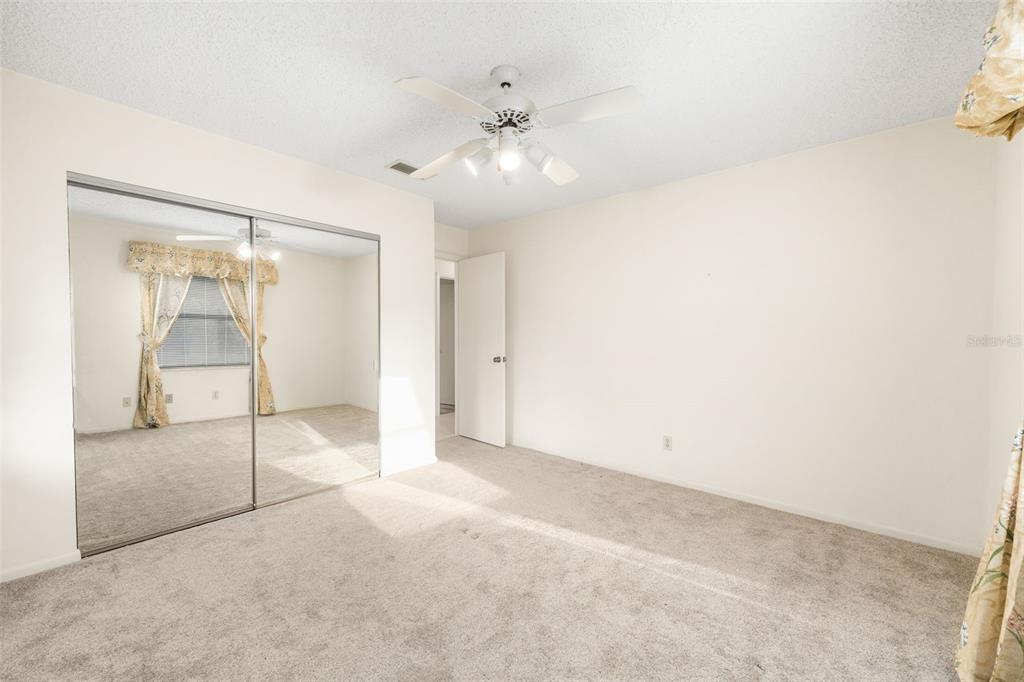 11606 Northwest 120th Terrace Alachua, FL 32615 - Photo 7 of 46 an empty room with a ceiling fan and glass door