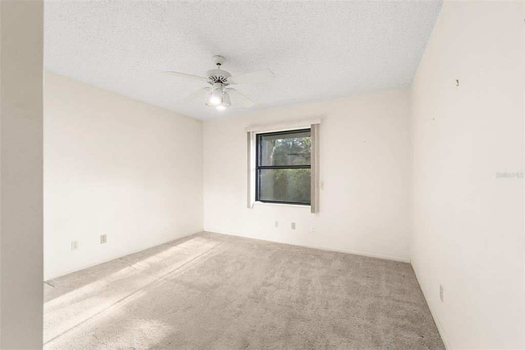 11606 Northwest 120th Terrace Alachua, FL 32615 - Photo 8 of 46 an empty room with a ceiling fan and a window