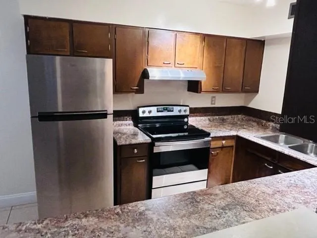 a kitchen with a refrigerator and a sink