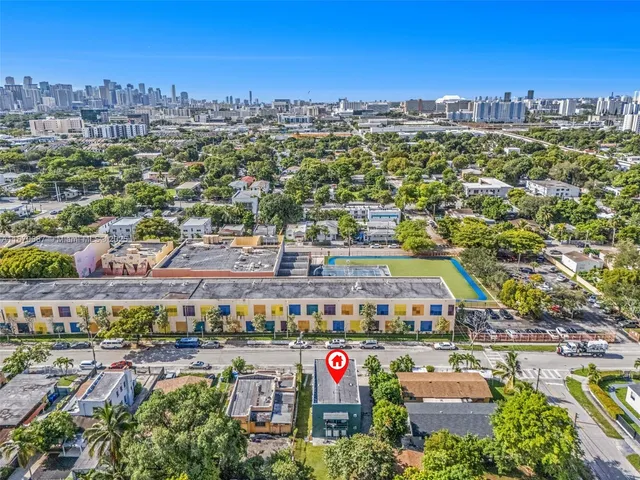 an aerial view of a house with a swimming pool