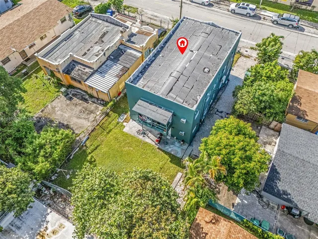 an aerial view of a house with pool