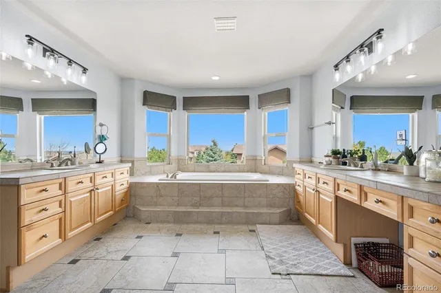 a large white kitchen with a large window