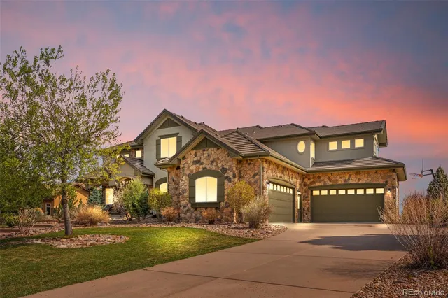 a front view of a building with a yard