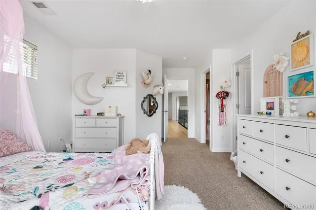 a bedroom with a bed and a dresser in it