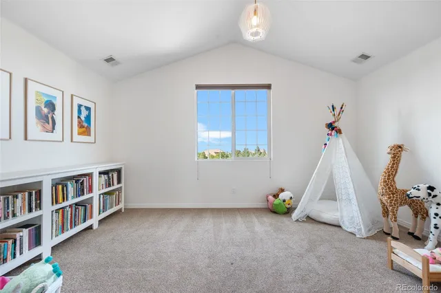 a view of room with window and book shelf
