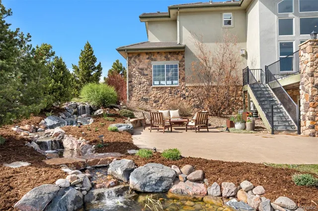 a backyard of a house with outdoor seating
