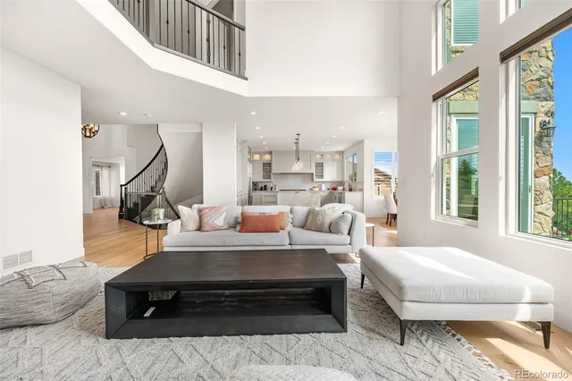 a living room with furniture a rug and a large window