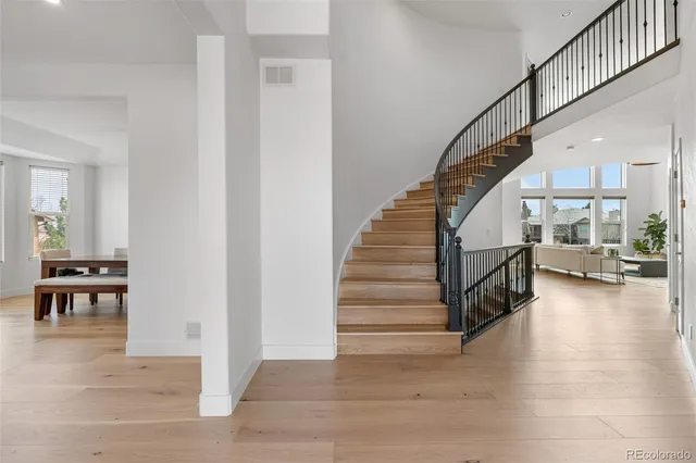 a view of entryway and hall with wooden floor