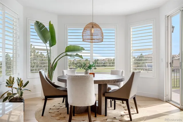 a dining room with furniture and a window