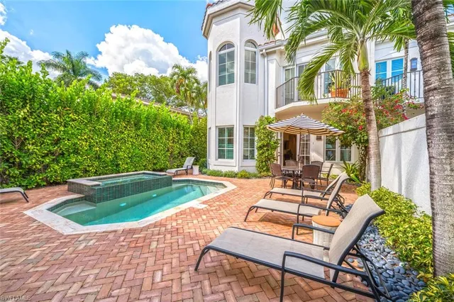 a view of a house with backyard porch and sitting area