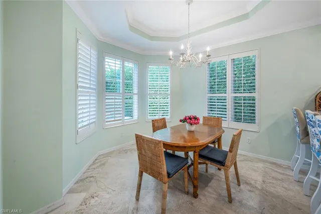 a view of a dining room with furniture and window