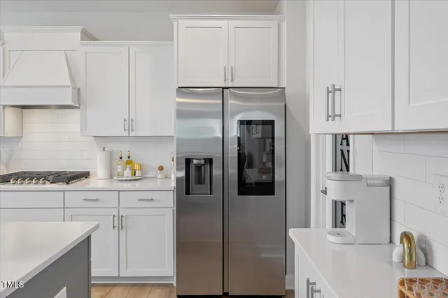 a kitchen with cabinets and appliances