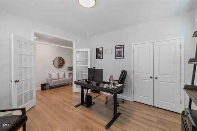 a view of a workspace with furniture and a window