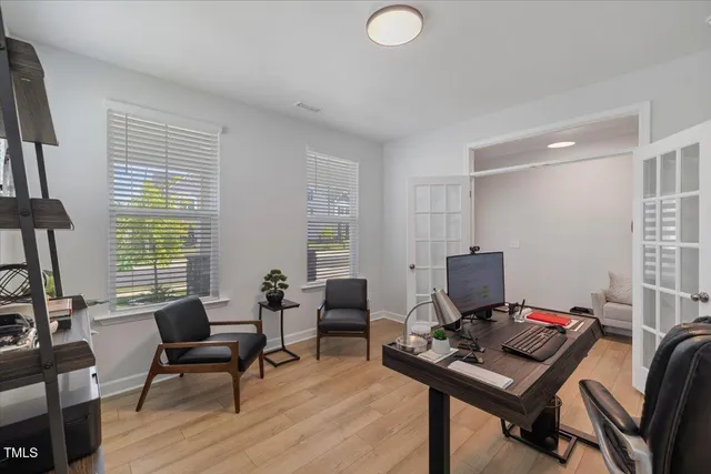 a view of a workspace with furniture and a window