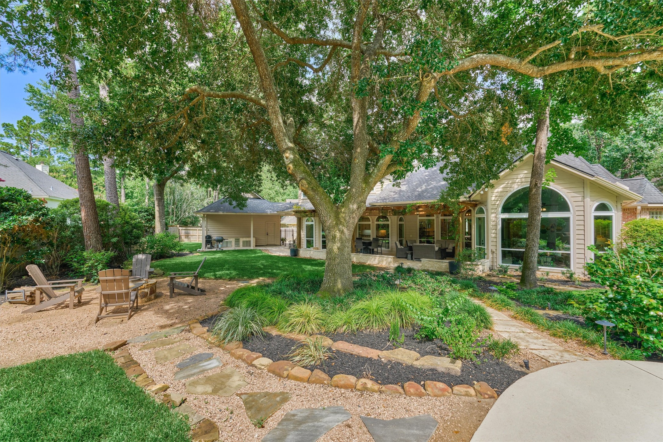 18 Treevine Court The Woodlands, TX 77381 - Photo 47 of 50 Enjoy a canopy of shade provided by the mature trees throughout the backyard.