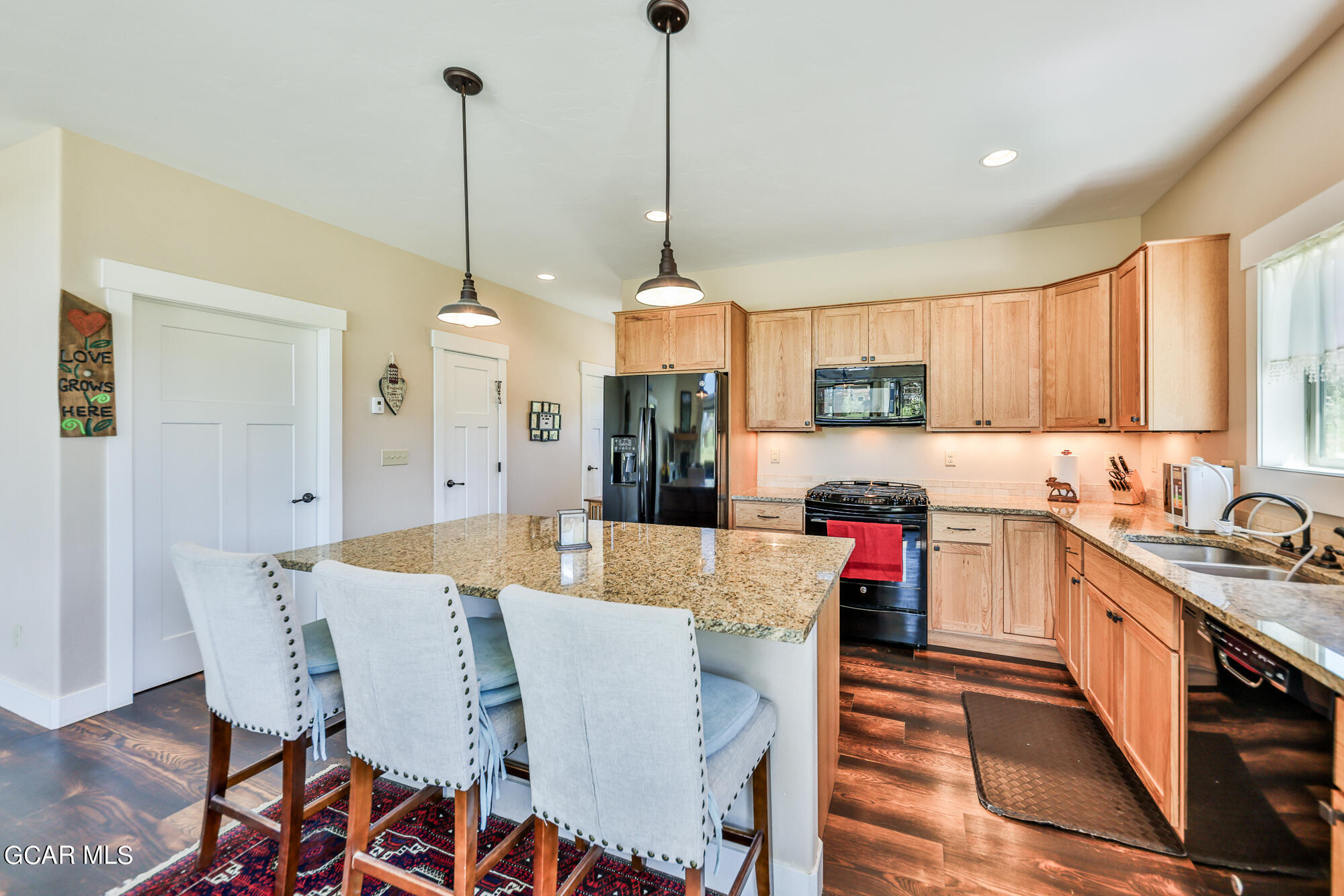 21 Brookside Trail Fraser, CO 80442 - Photo 15 of 62 a view of a dining room and livingroom with furniture wooden floor kitchen view and a chandelier