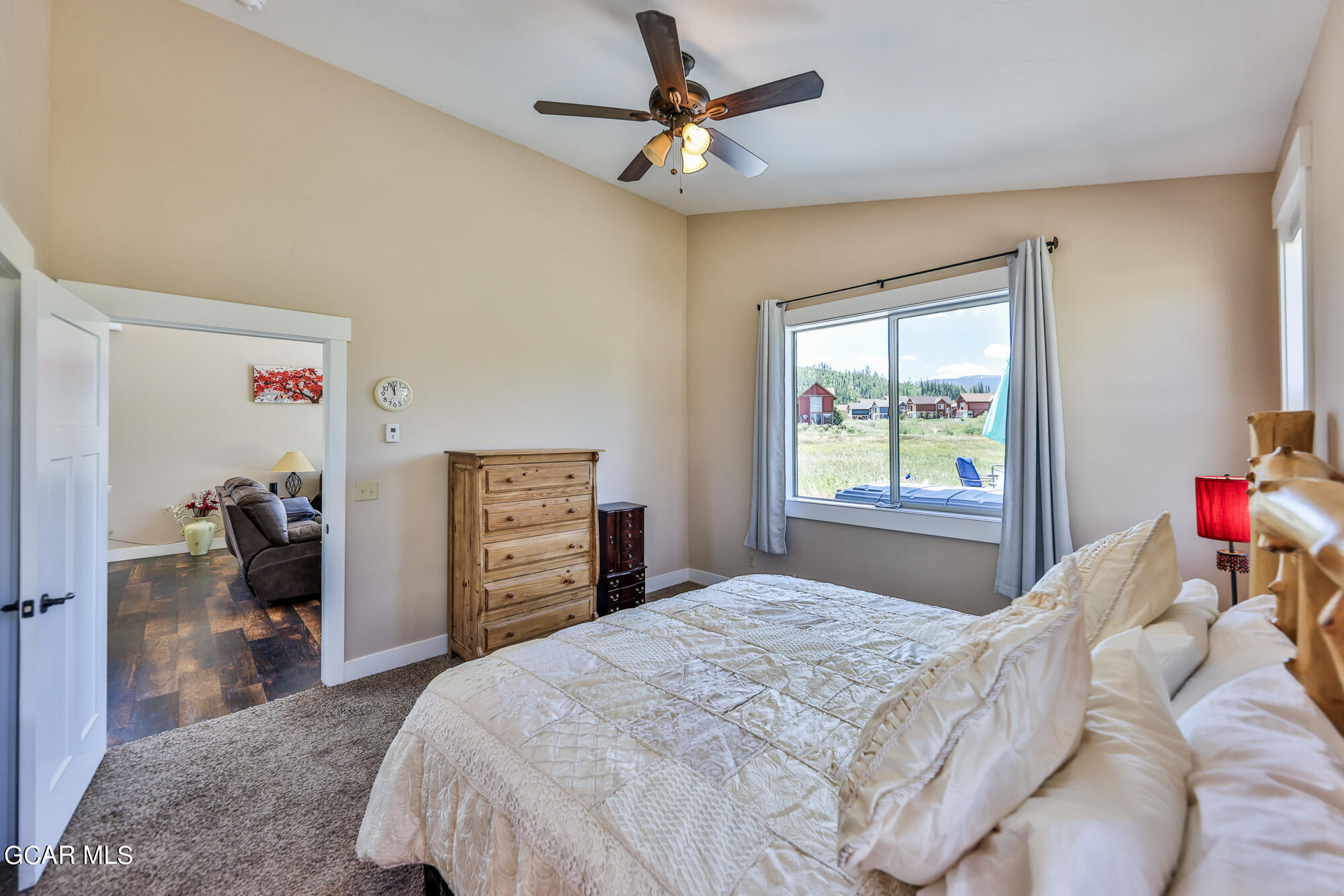 21 Brookside Trail Fraser, CO 80442 - Photo 19 of 62 a bedroom with a bed and a chandelier