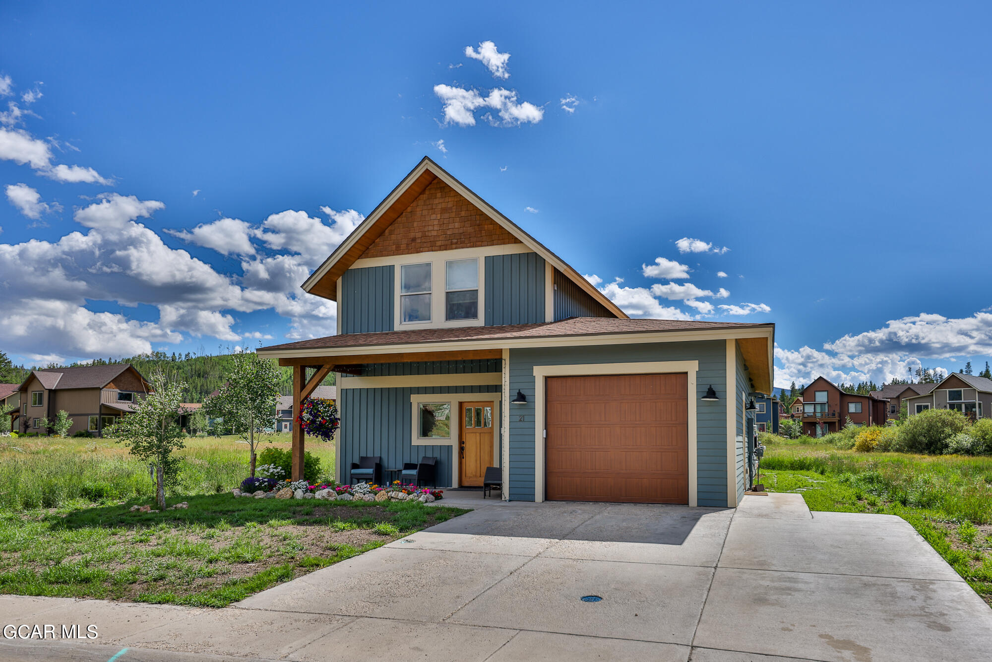 21 Brookside Trail Fraser, CO 80442 - Photo 2 of 62 a front view of a house with a yard and garage