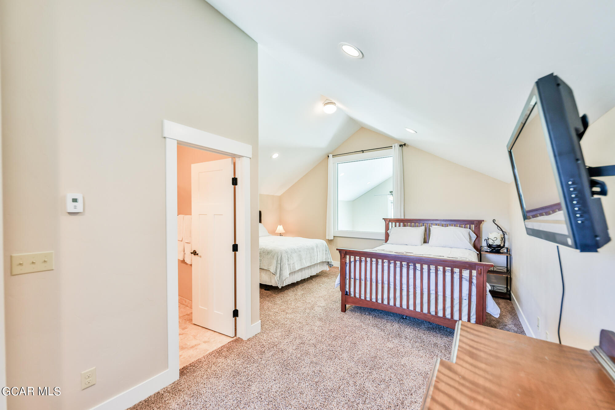 21 Brookside Trail Fraser, CO 80442 - Photo 26 of 62 a view of a bedroom with a bed and wooden floor
