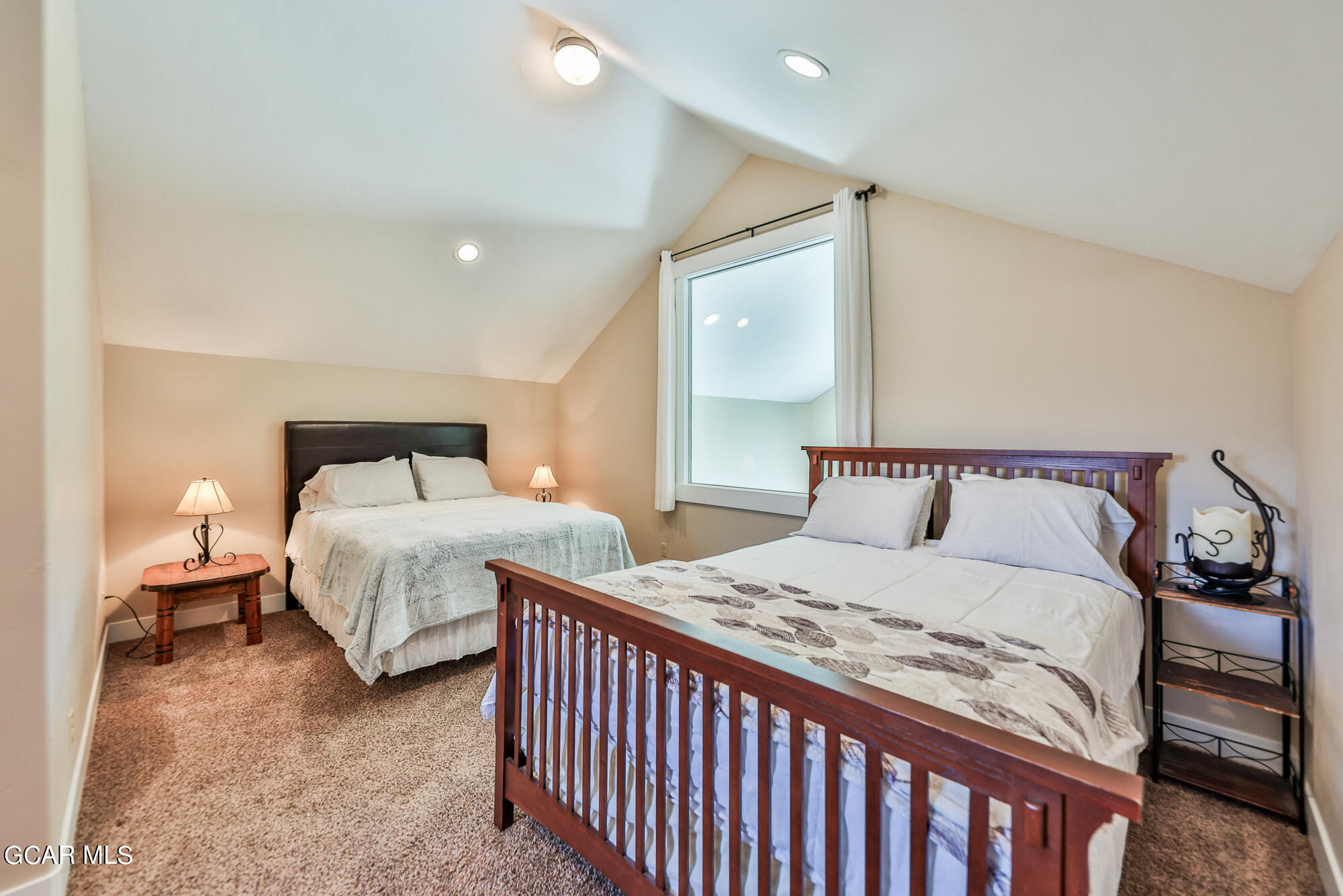 21 Brookside Trail Fraser, CO 80442 - Photo 28 of 62 a bedroom with a bed and a large mirror