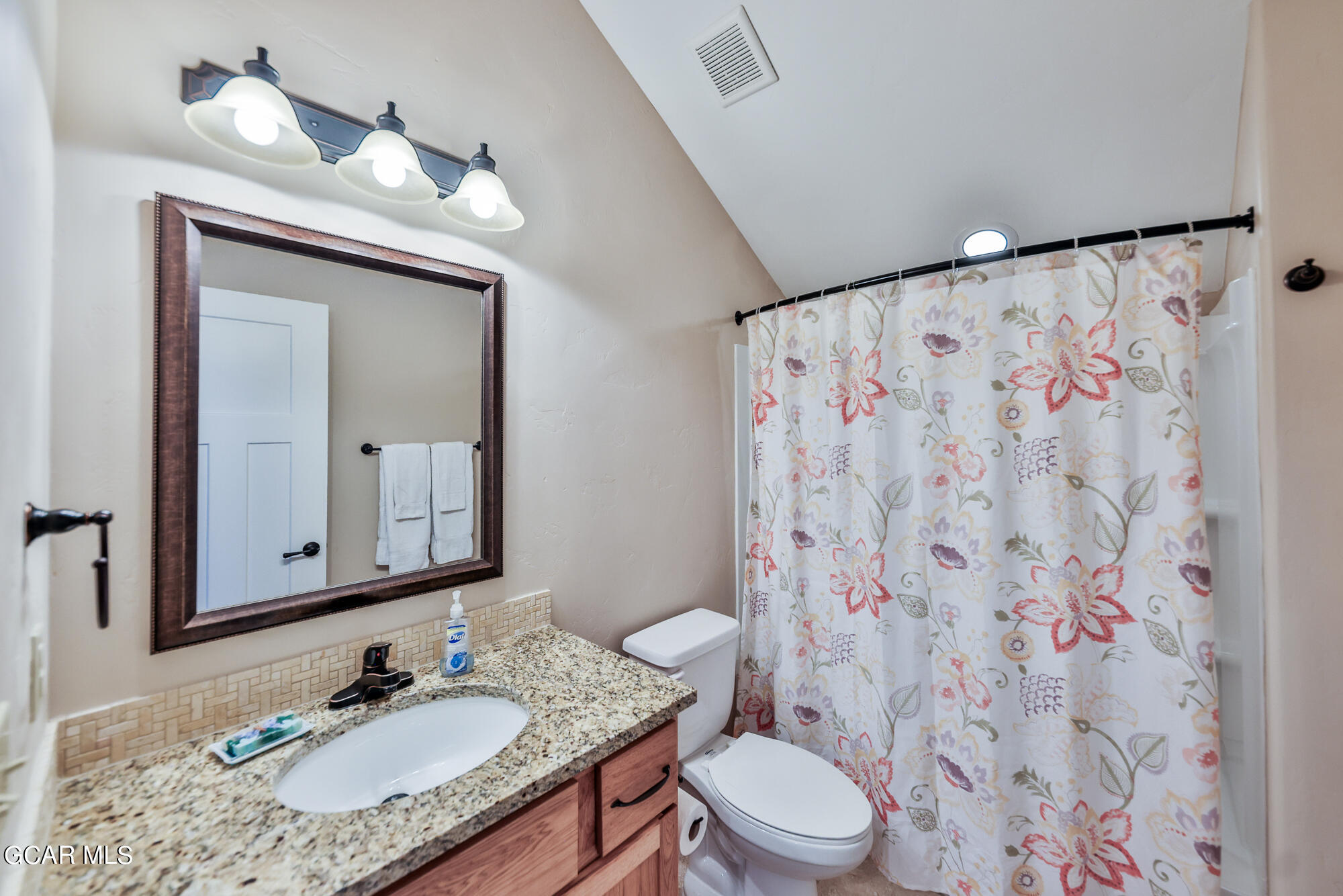 21 Brookside Trail Fraser, CO 80442 - Photo 32 of 62 a bathroom with a granite countertop sink a toilet and a mirror