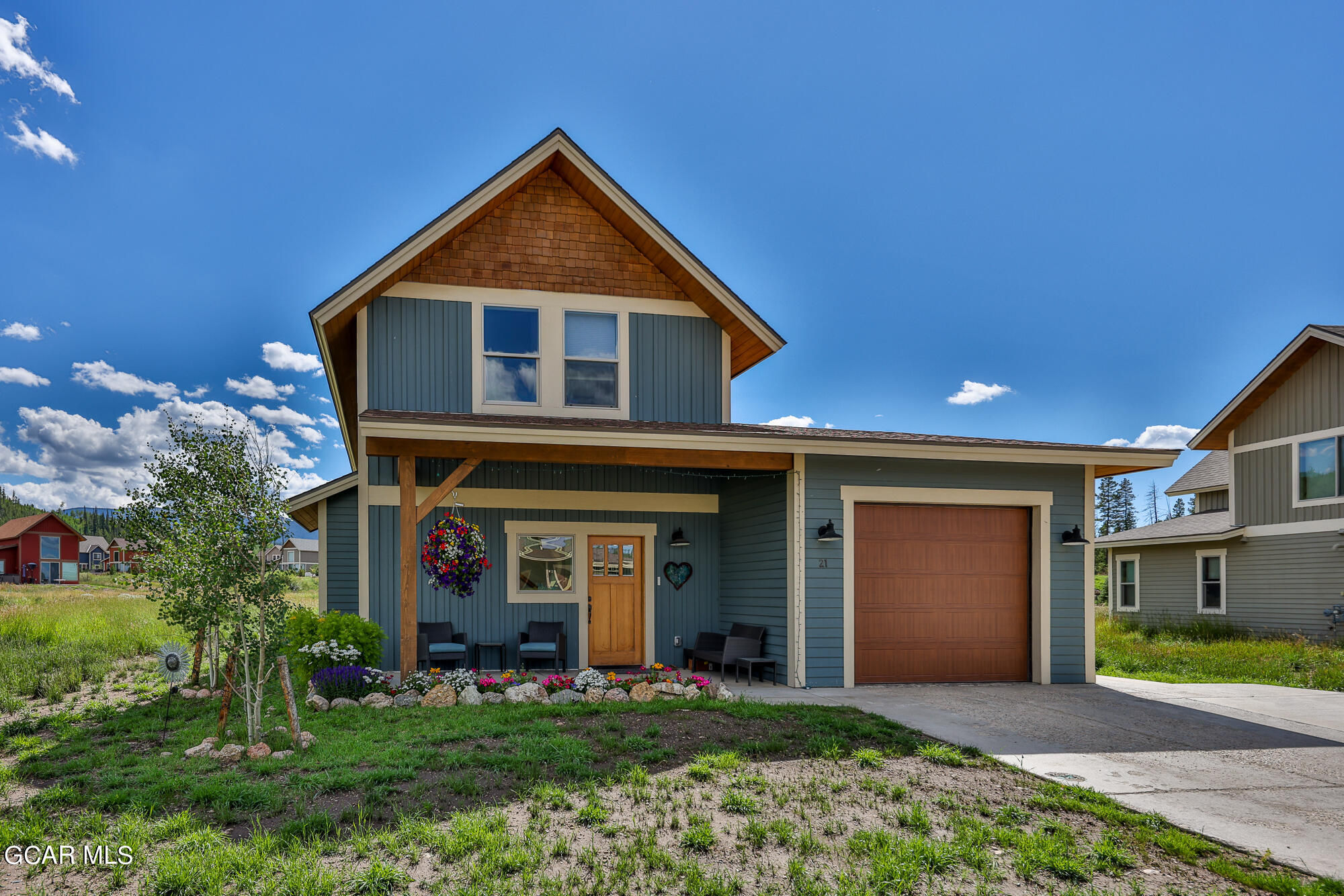 21 Brookside Trail Fraser, CO 80442 - Photo 39 of 62 a front view of a house with a yard and garage