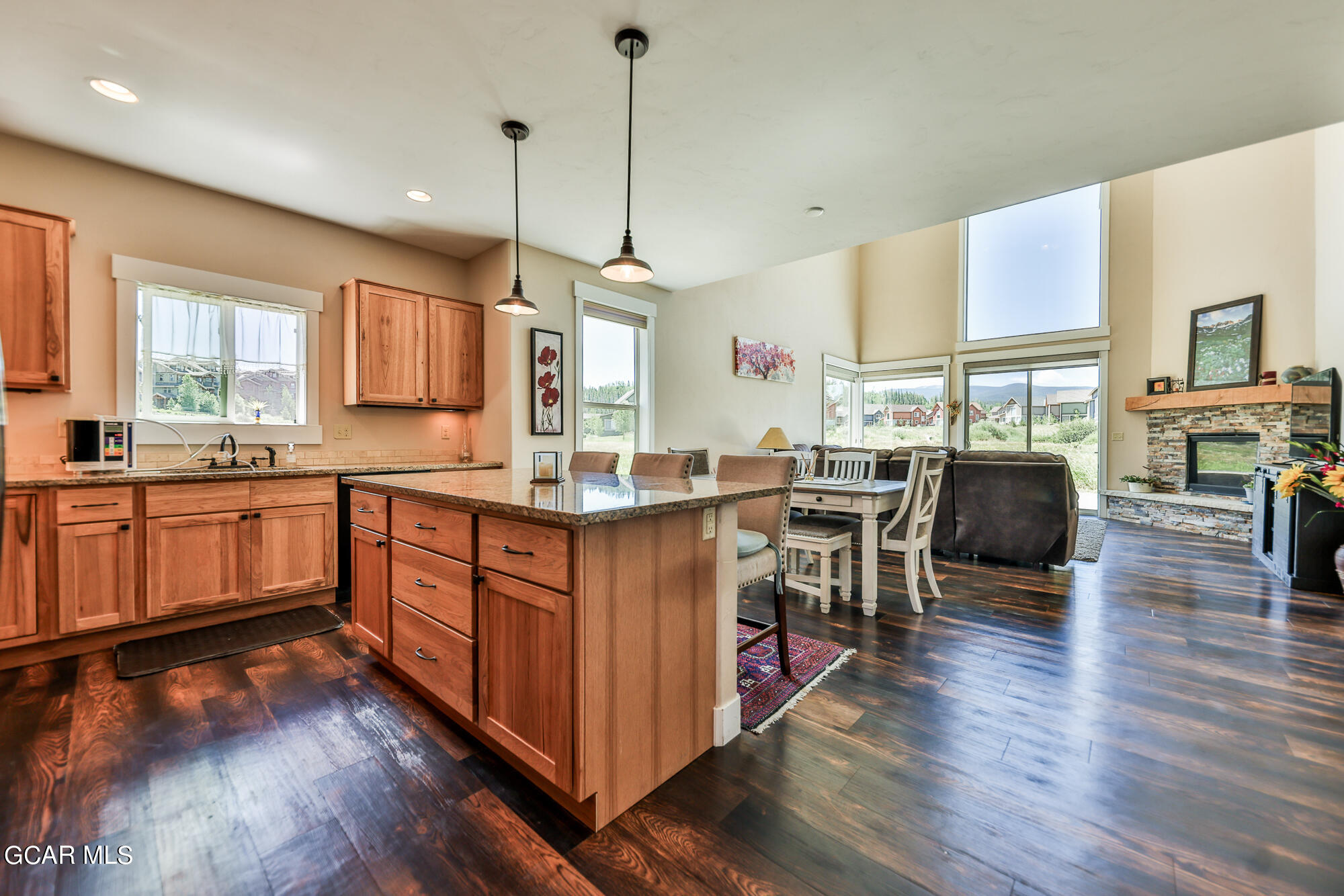 21 Brookside Trail Fraser, CO 80442 - Photo 5 of 62 a kitchen with stainless steel appliances granite countertop wooden floors and white cabinets