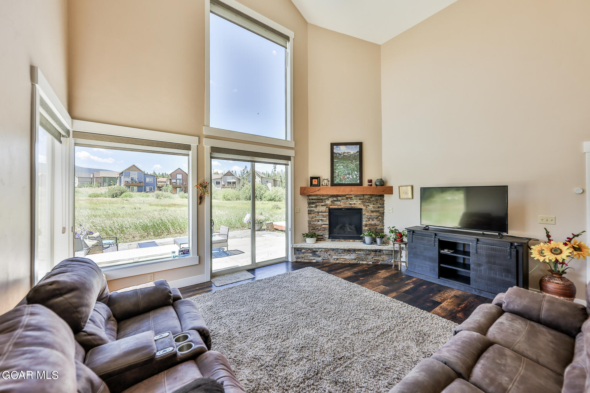 21 Brookside Trail Fraser, CO 80442 - Photo 7 of 62 a living room with furniture a fireplace and a flat screen tv