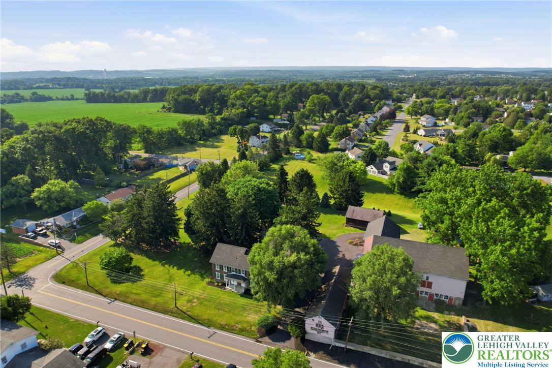 4682 Steuben Road Bethlehem, PA 18020 - Photo 67 of 79 An aerial perspective reveals a vibrant neighborhood nestled among fields and mature trees, offering a sense of community.