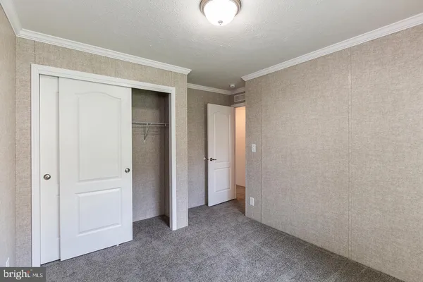 an empty room with closet area