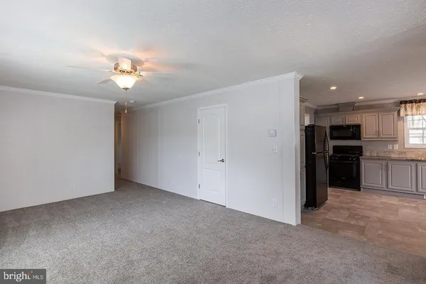 a view of a kitchen with a sink and a refrigerator