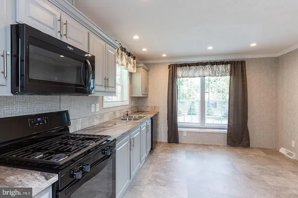 a kitchen with a stove and a microwave