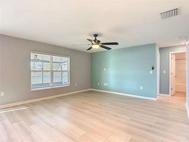 a view of a livingroom with a ceiling fan and window