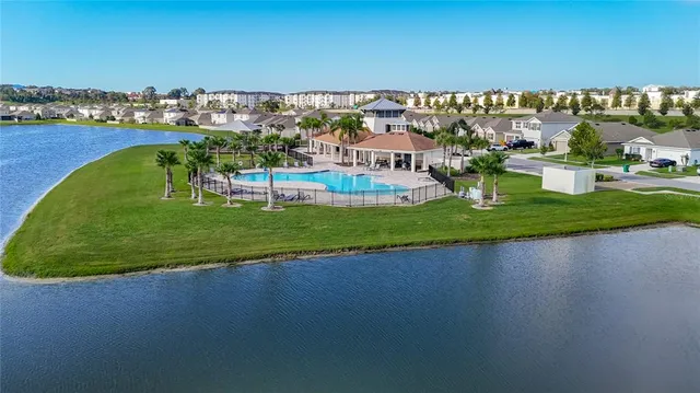a view of a hallway with wooden floor and a bathroom