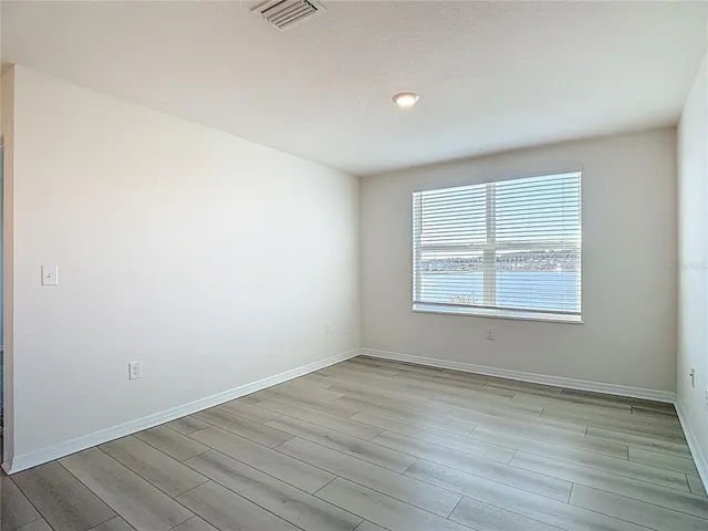 a bathroom with a window and a shower