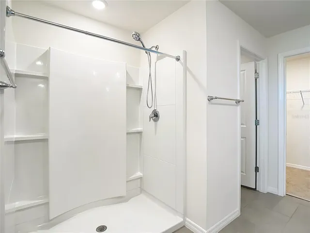 an aerial view of a house with a garden and lake view