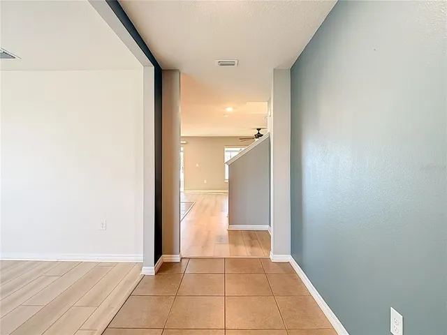 a view of a room with wooden floor