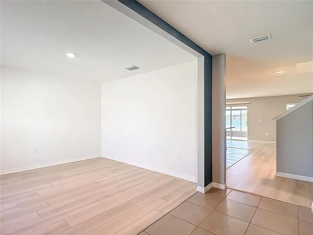 a kitchen with stainless steel appliances granite countertop a sink and a stove top oven with wooden floor