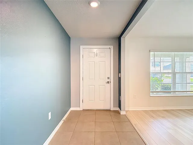 a kitchen with a refrigerator and cabinets