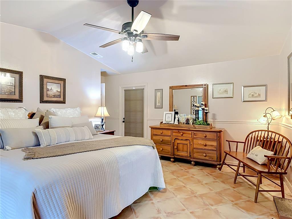 1395 Maytown Road Osteen, FL 32764 - Photo 30 of 65 a bedroom with a bed and a chandelier