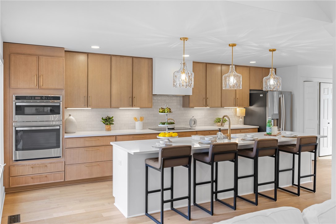 117 Riverpoint Drive Clemson, SC 29631 - Photo 16 of 47 This modern kitchen features a spacious island and bright pendant lighting.