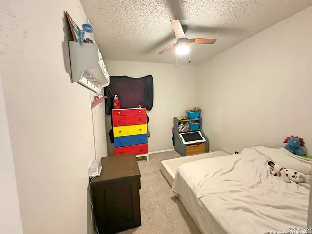 a room with bed and painting on the wall