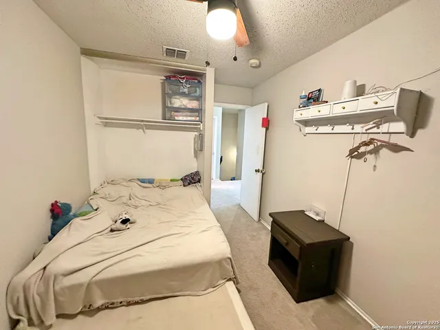 a bedroom with bed and window