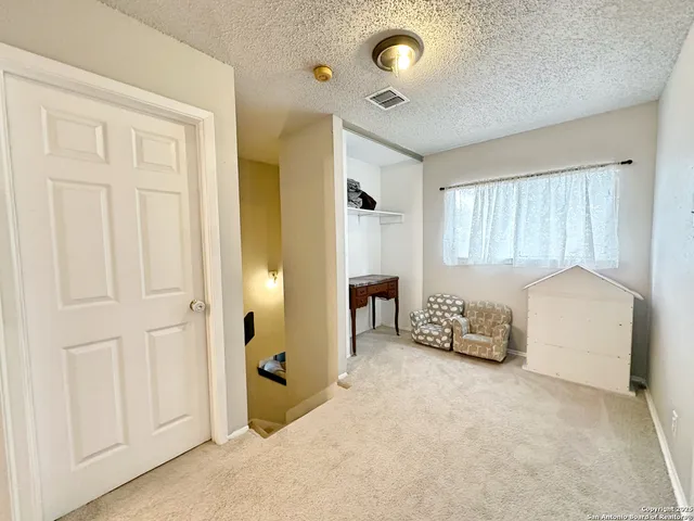 an empty room with windows and closet