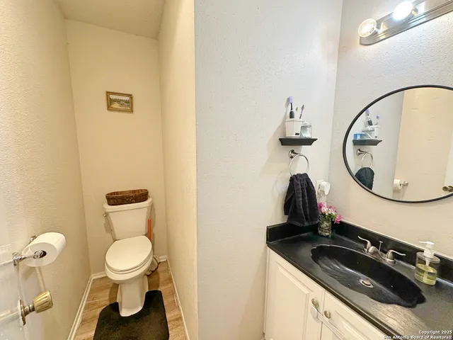 a bathroom with a toilet and a mirror