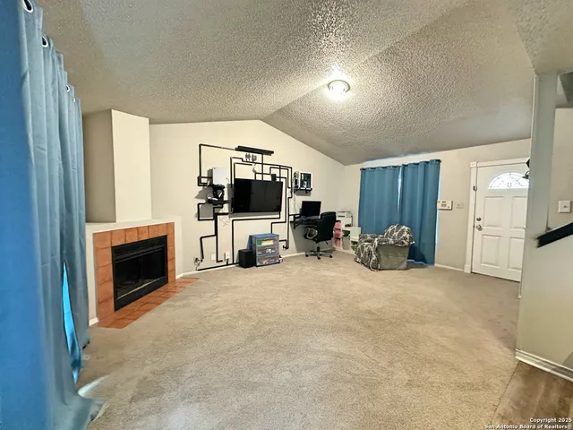a view of a livingroom with a fireplace and a couch