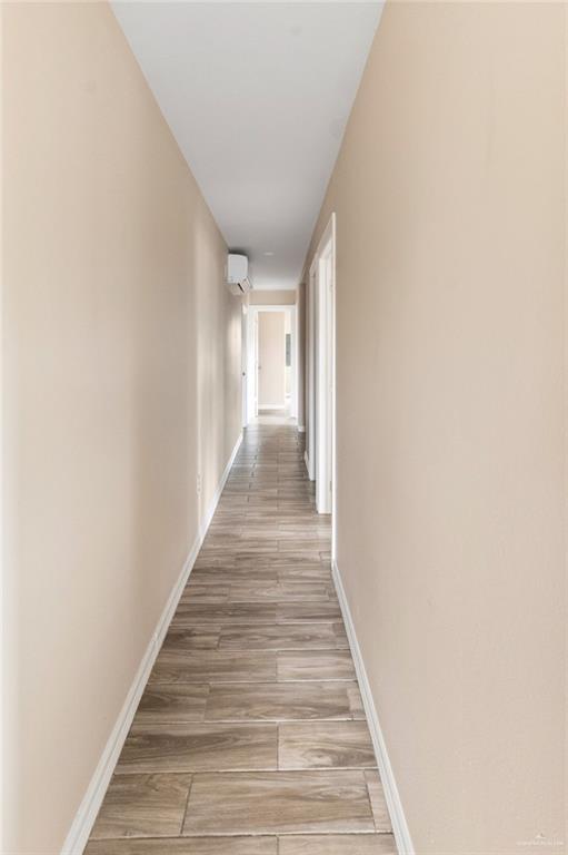 811 Carlson Street Elsa, TX 78538 - Photo 5 of 10 a view of a hallway with wooden floor