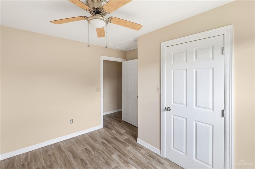 811 Carlson Street Elsa, TX 78538 - Photo 6 of 10 an empty room with a ceiling fan and carpet
