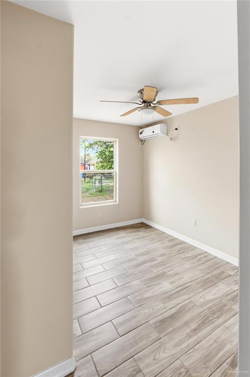 811 Carlson Street Elsa, TX 78538 - Photo 8 of 10 an empty room with windows and fan